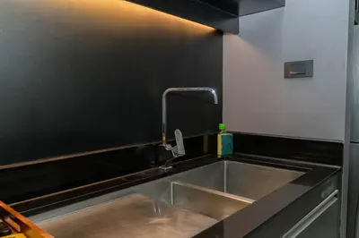 a kitchen with a sink and a faucet at Beachfront and Deluxe Pool Access Patong Phuket in Patong Beach
