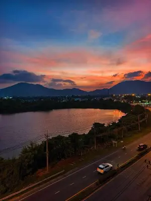 a sunset over a river and a road with cars at dcondo Mine Phuket in Kathu