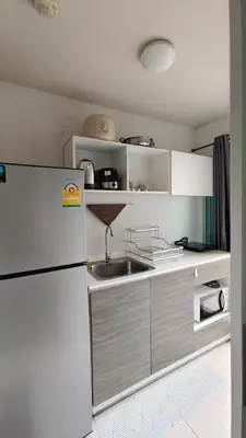 a kitchen with a refrigerator and a sink at dcondo Mine Phuket in Kathu