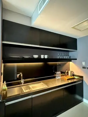 a kitchen with a sink and a counter at Beachfront Family Pool 1 BR 1 Living Patong Phuket in Patong Beach