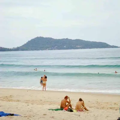a group of people sitting on the beach at Beachfront Family Pool 1 BR 1 Living Patong Phuket in Patong Beach