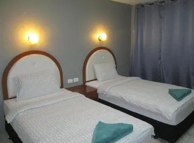 two beds in a small room with at Sunflower Guesthouse in Karon Beach