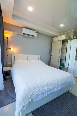 a bedroom with a white bed in a room at White Room in Ban Mai Salae