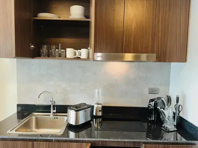 a kitchen with a sink and a counter top at Praud Karon in Karon Beach