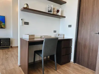 a desk with a chair in a room at Praud Karon in Karon Beach