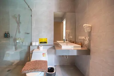 a bathroom with a sink and a toilet and a mirror at Bang tao modern holiday style pool view high speed WiFi in Laguna Phuket
