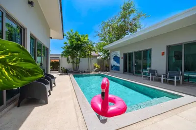 a pool with a inflatable flamingos in a house at Bang tao modern holiday style pool view high speed WiFi in Laguna Phuket