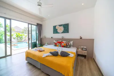 a bedroom with a bed with towels on it at Bang tao modern holiday style pool view high speed WiFi in Laguna Phuket
