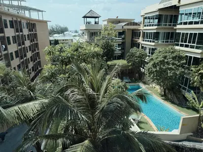 an aerial view of a hotel with a palm tree at Proud Karon 303 in Karon Beach
