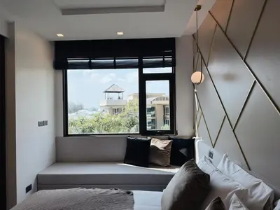 a living room with a bench and a window at Proud Karon 303 in Karon Beach