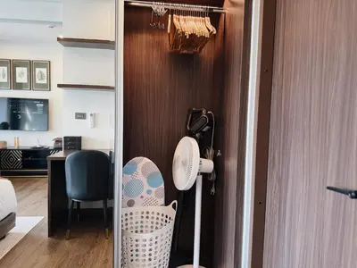 a room with a door with a fan and a desk at Proud Karon 303 in Karon Beach