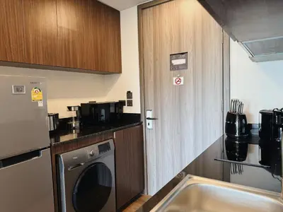 a small kitchen with a washer and a sink at Proud Karon 303 in Karon Beach