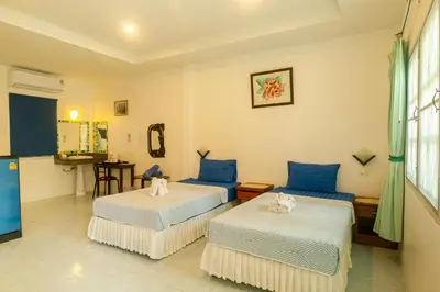 a hotel room with two beds and a kitchen at The Golden Beach Resort Naiyang in Nai Yang Beach