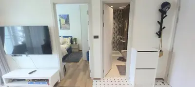 a living room with a tv and a mirror at MO1 Halo 2-bedroom ВатСaп66935B2I976 in Nai Yang Beach