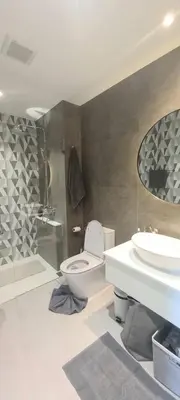 a bathroom with a toilet and a sink and a shower at MO1 Halo 2-bedroom ВатСaп66935B2I976 in Nai Yang Beach