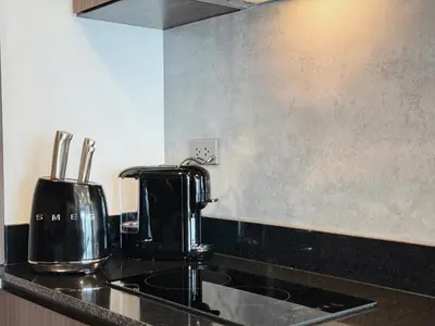 a kitchen counter with a coffee maker on the counter at Praud Karon 605 in Karon Beach
