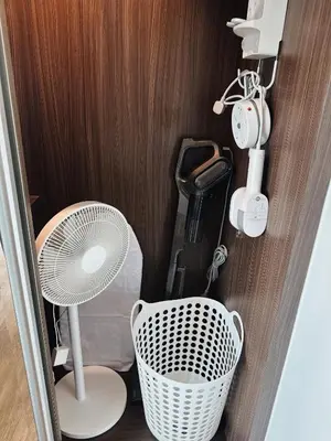 a room with a white chair and a fan at Praud Karon 605 in Karon Beach