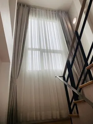 a window with white curtains in a room at PhuketMadameBuppa Siwali Village in Ban Phlu Yai