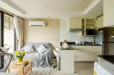 a small living room with a couch and a kitchen at Room 303 Rawai Beach Condo in Nai Harn Beach