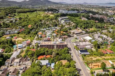 an aerial view of a city with houses and a road at Room 303 Rawai Beach Condo in Nai Harn Beach