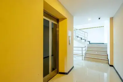 an empty hallway with a yellow wall in a building at Room 303 Rawai Beach Condo in Nai Harn Beach