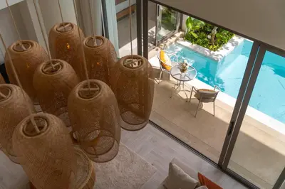 a group of vases in a room with a pool at \u4e91\u6816\u522b\u9662 Cloudrest Villa in Phuket Town