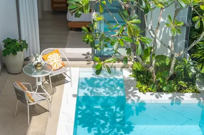 a patio with a table and chairs and a pool at \u4e91\u6816\u522b\u9662 Cloudrest Villa in Phuket Town