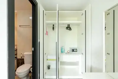 a bathroom with a toilet and a glass shower at Room 402 Rawai Beach Condo in Nai Harn Beach