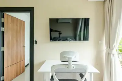 a white table and chair in a room with a mirror at Room 402 Rawai Beach Condo in Nai Harn Beach