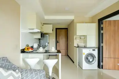 a kitchen with a washing machine in a room at Room 402 Rawai Beach Condo in Nai Harn Beach