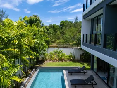 a view of the pool from the balcony of a house at Modern Minimalist 6 Bedroom Light Luxury Villa Private Pool Golf Course Laguna Park in Bang Tao Beach