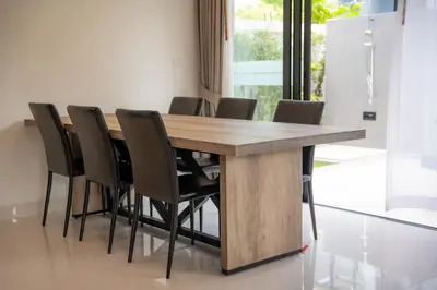 a wooden table with chairs around it in a room at Modern Minimalist 6 Bedroom Light Luxury Villa Private Pool Golf Course Laguna Park in Bang Tao Beach