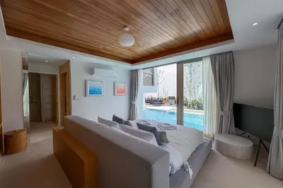 a bedroom with a large bed and a large window at Brand-New 3BR Designer Pool Villa in Exclusive Residence LuxPride 4 L20 in Bang Tao Beach