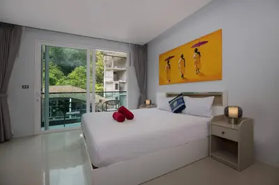 a bedroom with a white bed and a window at Tropical Retreat near Patong - Emerald Hill 420 in Patong Beach