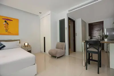 a bedroom with a bed and a desk and a chair at Tropical Retreat near Patong - Emerald Hill 420 in Patong Beach