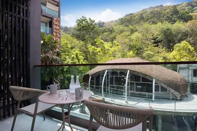 a balcony with a table and chairs and a view at Tropical Retreat near Patong - Emerald Hill 420 in Patong Beach