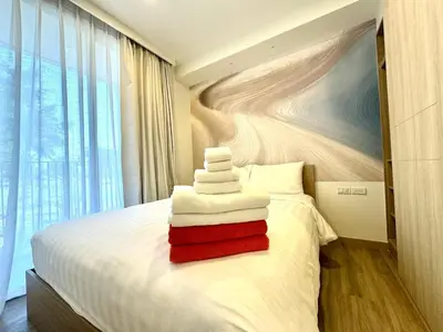 a bedroom with a bed with towels on it at Laguna Skypark spacious 1 bedroom apart Bangtao in Laguna Phuket