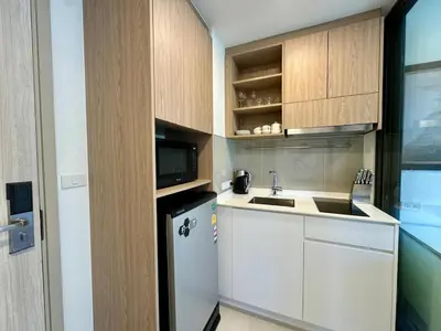 a small kitchen with a sink and a refrigerator at Laguna Skypark spacious 1 bedroom apart Bangtao in Laguna Phuket