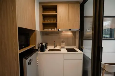 a small kitchen with a sink and a refrigerator at Laguna Skypark spacious 1 bedroom apart Bangtao in Laguna Phuket