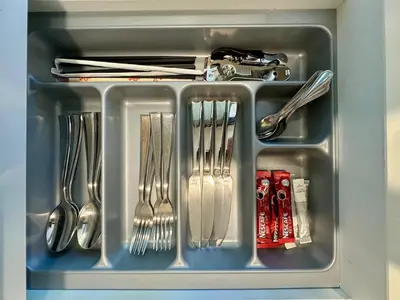 a tray with forks and spoons and utensils at Laguna Skypark spacious 1 bedroom apart Bangtao in Laguna Phuket