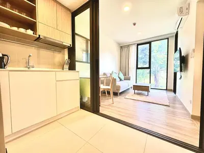 an open kitchen with a view of a living room at Laguna Skypark spacious 1 bedroom apart Bangtao in Laguna Phuket