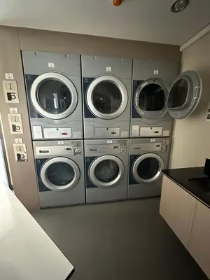 a group of four washing machines in a room at Laguna Skypark spacious 1 bedroom apart Bangtao in Laguna Phuket