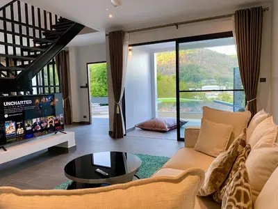 a living room with a couch and a table at Viewpoint Villa with Private Infinity Pool - 2BR in Rawai Beach