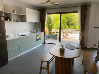 a kitchen with a table and a dining room at Viewpoint Villa with Private Infinity Pool - 2BR in Rawai Beach