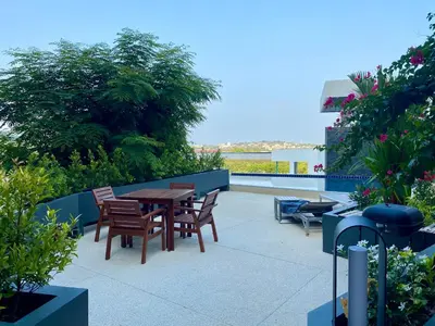 a patio with a wooden table and chairs at Viewpoint Villa with Private Infinity Pool - 2BR in Rawai Beach
