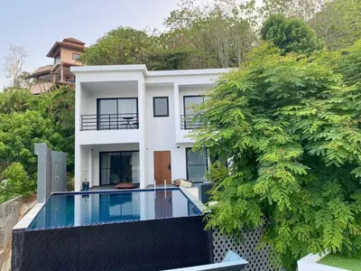 a house with a swimming pool in front of it at Viewpoint Villa with Private Infinity Pool - 2BR in Rawai Beach
