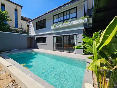 a swimming pool in front of a house at Modern 2 Bedroom Pool Villa in Kamala in Kamala Beach