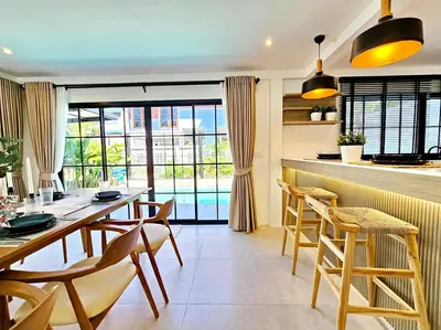 a kitchen and dining room with a table and chairs at Modern 2 Bedroom Pool Villa in Kamala in Kamala Beach