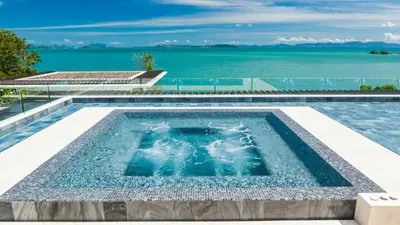 a swimming pool with the ocean in the background at Villa Amarapura in Ko Lek