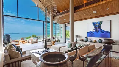 a living room filled with furniture and a large window at Villa Amarapura in Ko Lek